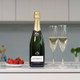 Champagne Bernard Remy Gift Box. A bottle of champagne is displayed on a kitchen counter next to two filled Champagne flutes. A plate of fresh strawberries sits nearby, adding a pop of color to the scene. The background features muted tones and soft lighting, creating an inviting atmosphere. Champagne Bernard Remy Gift Box. A bottle of champagne is displayed on a kitchen counter next to two filled Champagne flutes. A plate of fresh strawberries sits nearby, adding a pop of color to the scene. The background features muted tones and soft lighting, creating an inviting atmosphere.